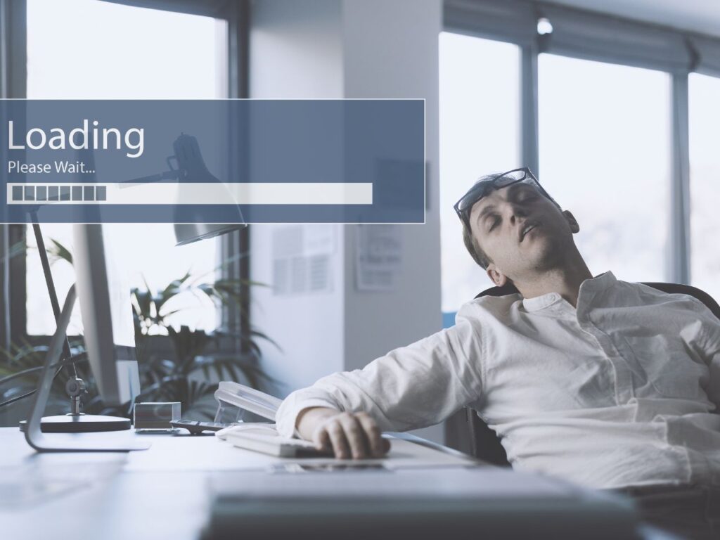 Website slowly loading in progress while person is asleep at desk waiting