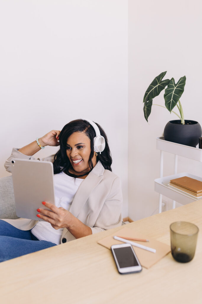 Black woman smiling while reading her iPad
