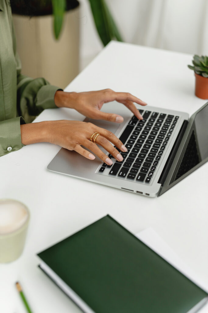hands typing on a laptop