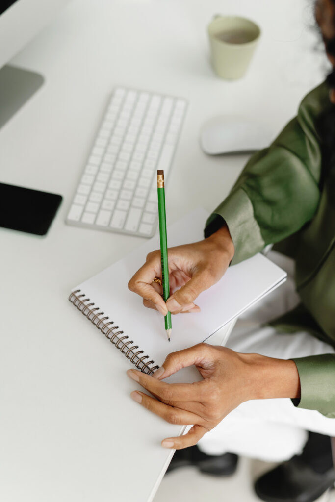 Woman writing on a notepad