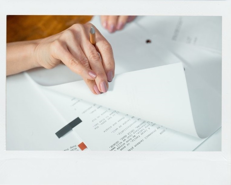 woman's hand turning the page of a script