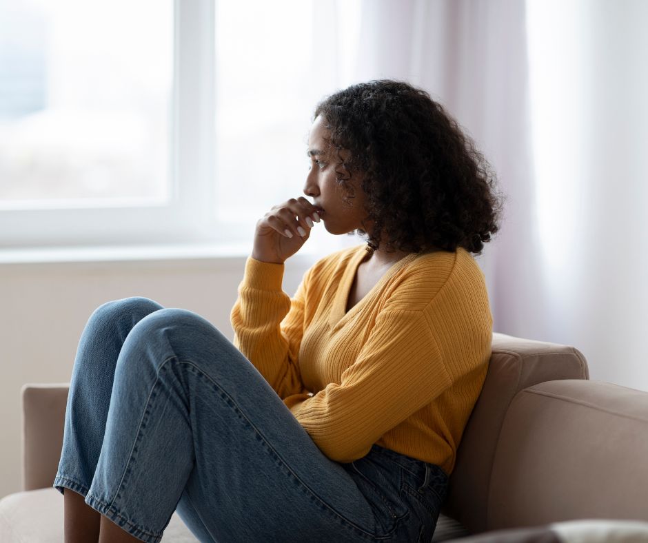 teen sitting on couch worried