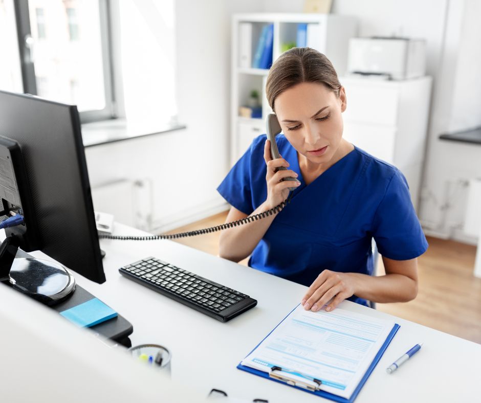 Receptionist at doctor office on phone in blue