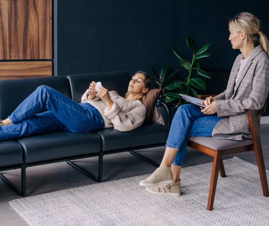 patient lying on couch in therapist office