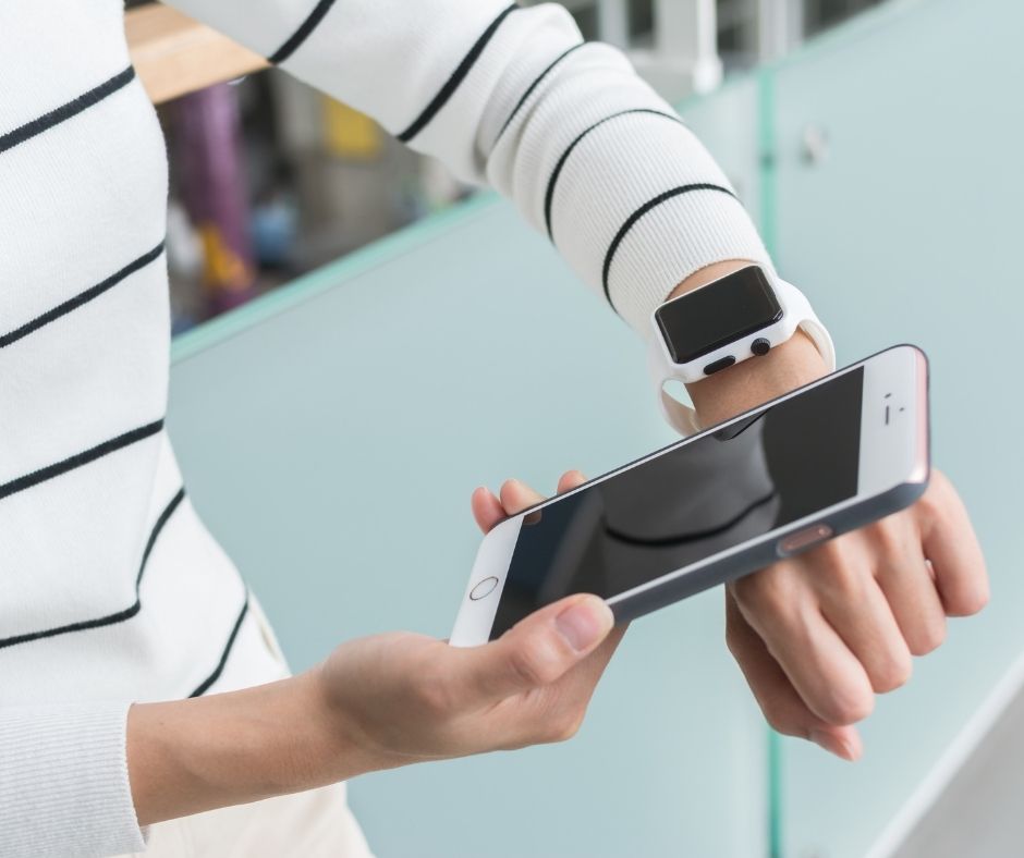 Woman checking iphone with Apple watch
