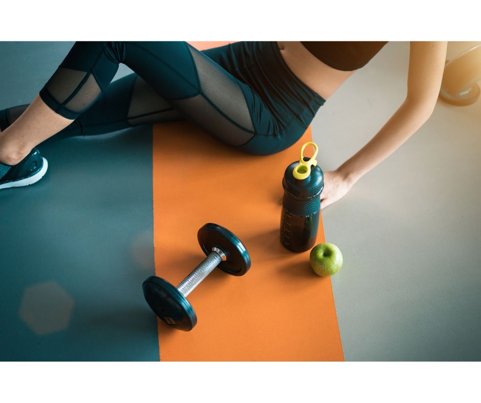 Woman sitting on an exercise mat
