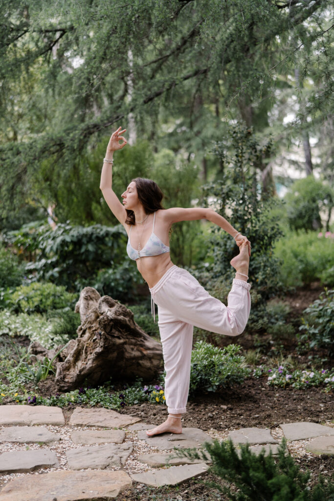 Woman standing in  a yoga pose in the park